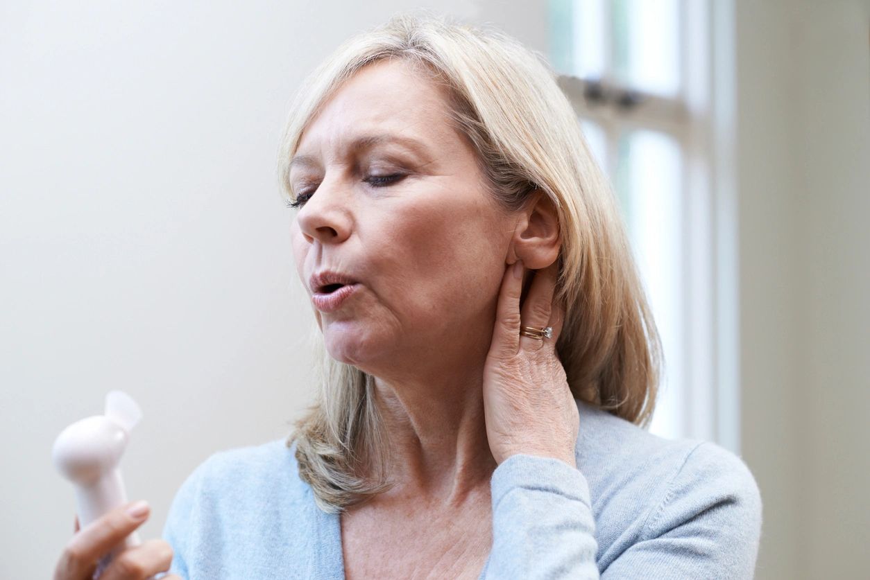 A woman with her mouth open and hand on the side of her face.