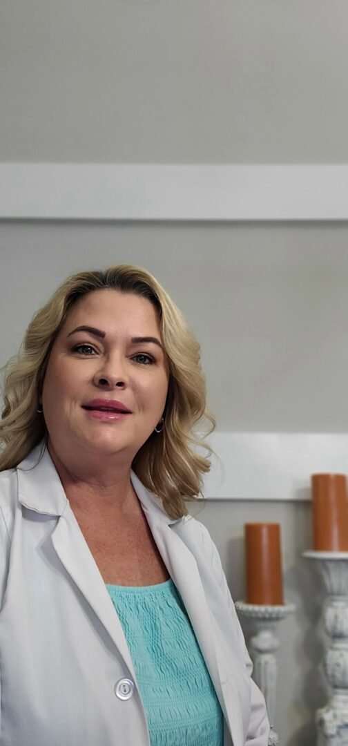 A woman in white shirt smiling for the camera.