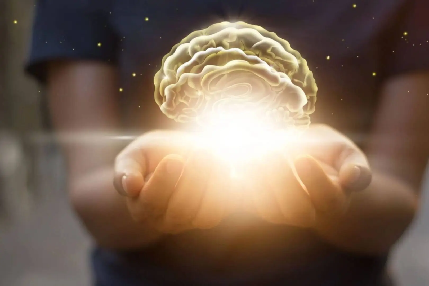 A person holding their hands out with a glowing brain in the middle.