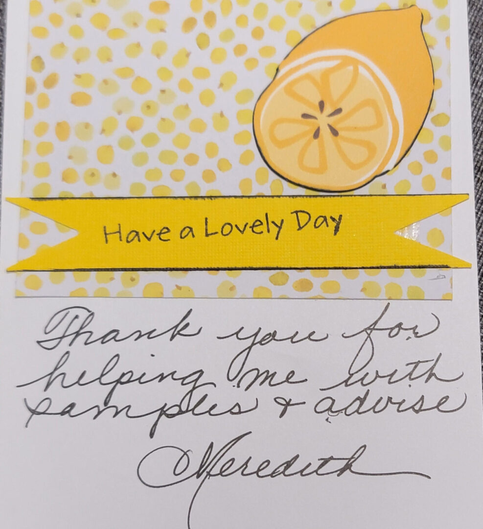 A card with a lemon and the words " have a lovely day ".